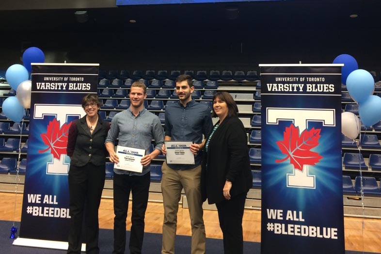 Vice-Provost of Students Sandy Welsh and Executive Director of Athletics & Physical Activity Beth Ali congratulate Paul Spooner and Sever Topan 