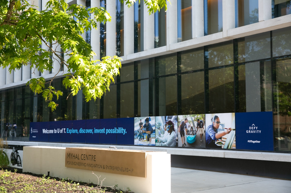 front of Myhal Centre, with a sign that says: Welcome to U of T. Explore, discover, invent possibility.