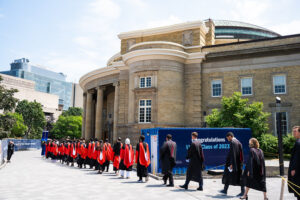 Graduating students walking toward convocation hall